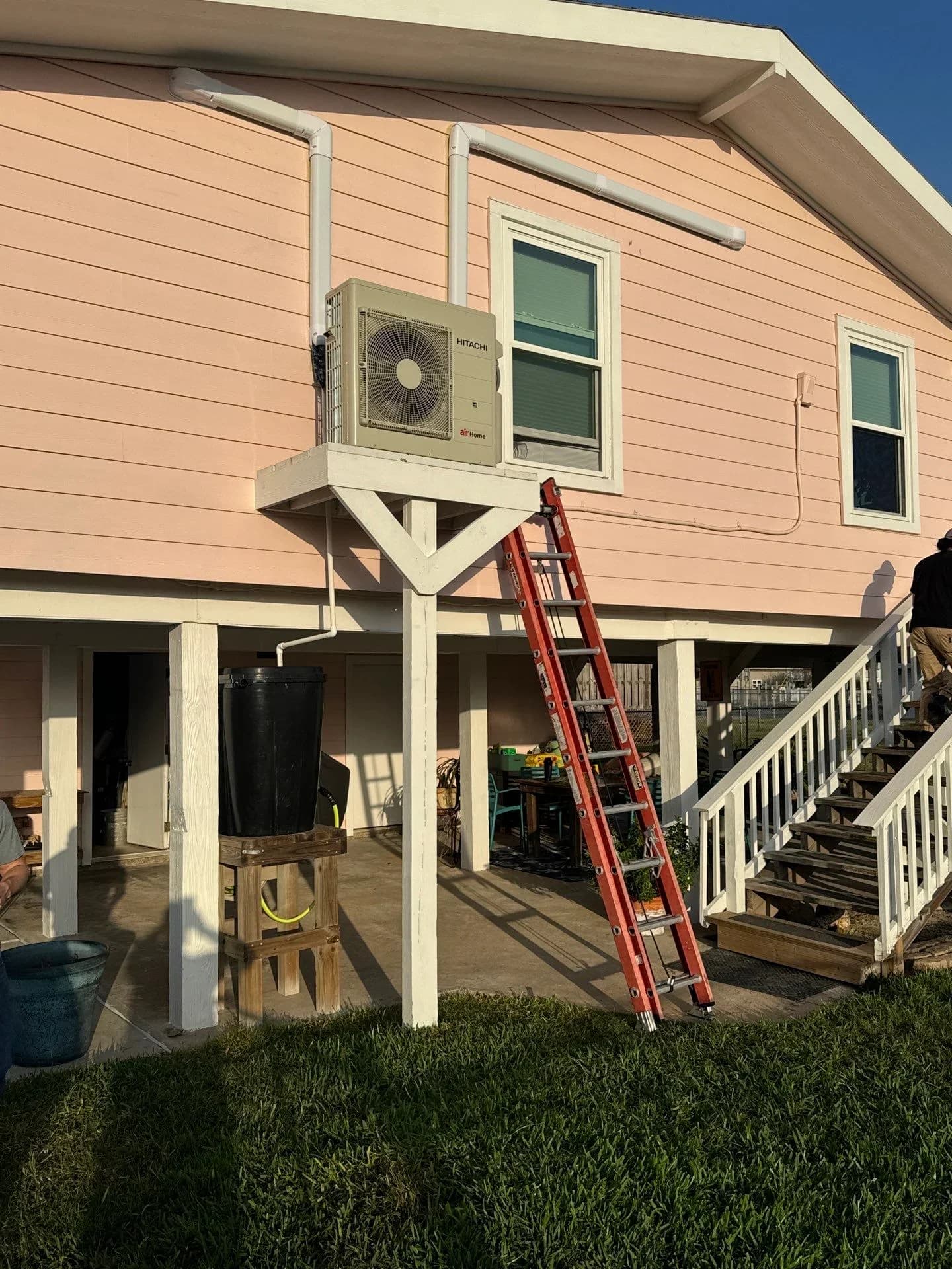 Ductless mini-split AC installation on a pink house in a Galveston TX
