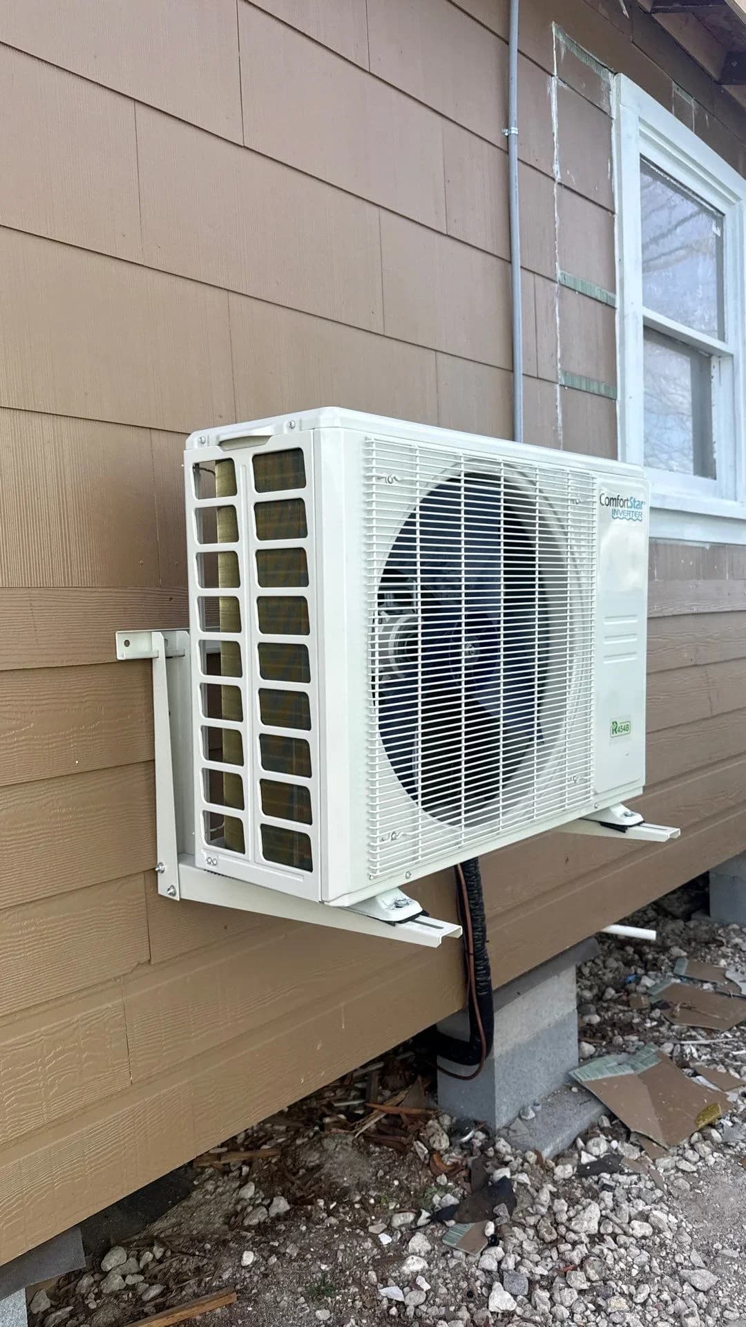 Ductless mini-split air conditioning unit installed on an exterior wall.